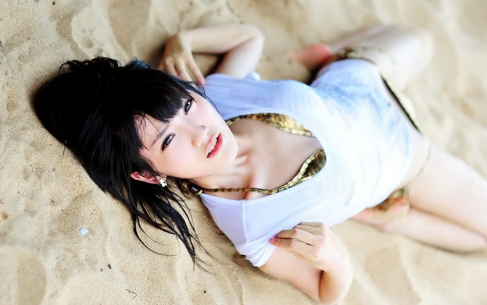 Woman lying on sand