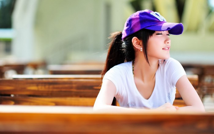 Young woman wearing a purple cap