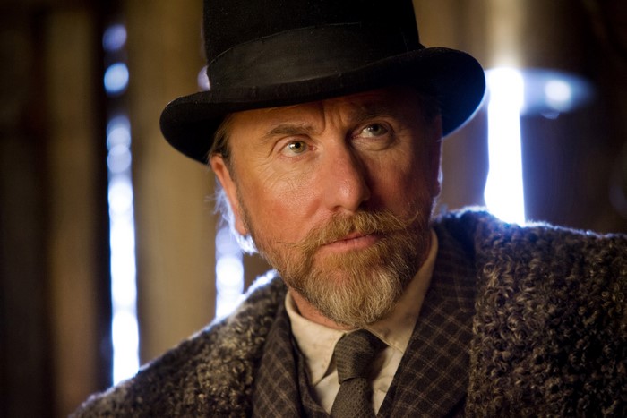 Tim Roth wearing a top hat and coat