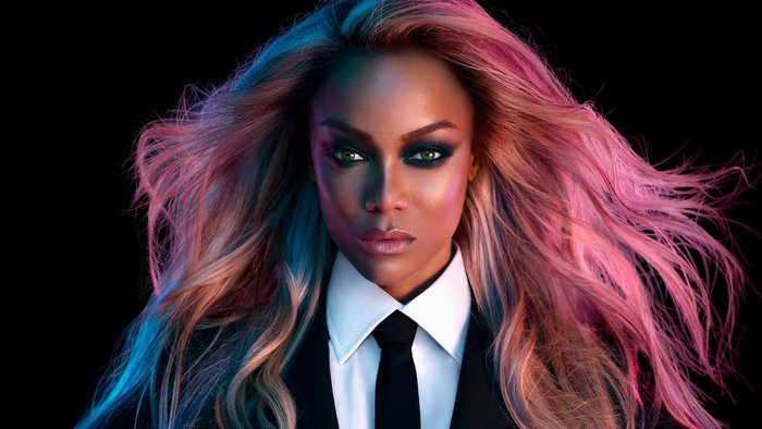 Tyra Banks in a suit with colorful hair