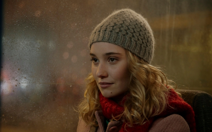 Déborah François wearing a hat and scarf