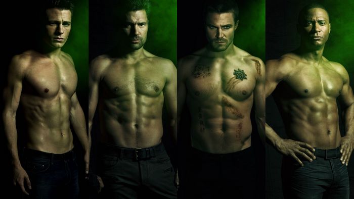 Four shirtless men with green lighting