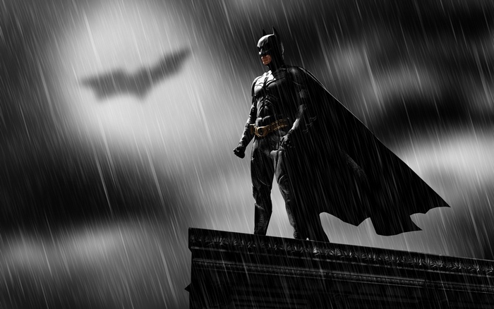 Batman on a rooftop in the rain