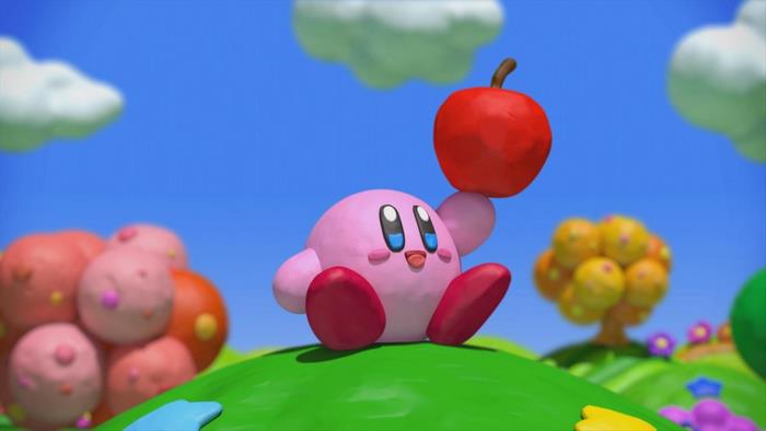 Kirby Holding a Red Apple on a Green Hill