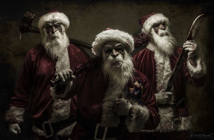 Three menacing Santas with weapons