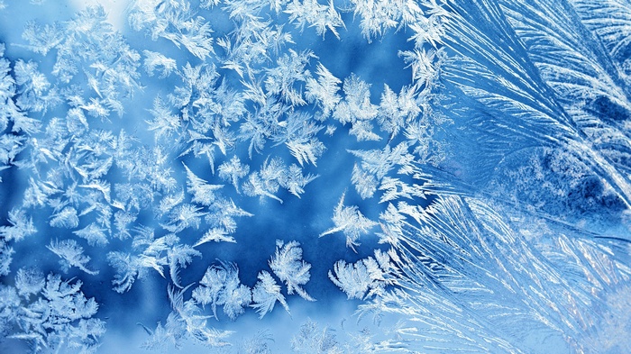 Close-up of frost patterns on a blue surface