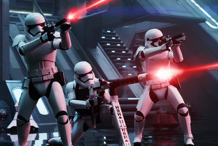 Stormtroopers firing blasters in a futuristic interior