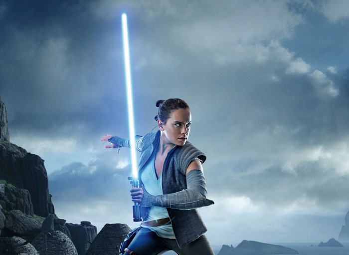 Rey from Star Wars holding a lightsaber