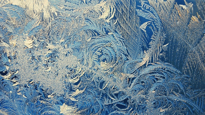 Close-up of frost patterns on a blue surface