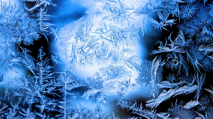 Close-up of frost patterns on a blue background