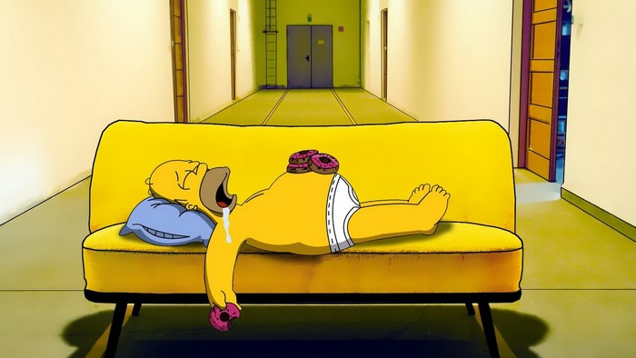 Homer Simpson sleeping on a couch with donuts