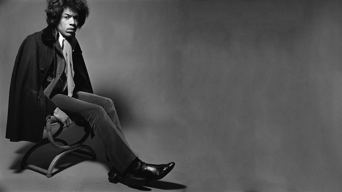 Jimi Hendrix sitting on a chair