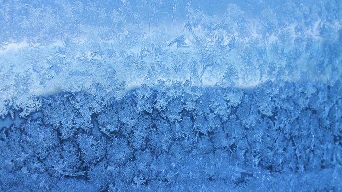 Frost patterns on a blue surface