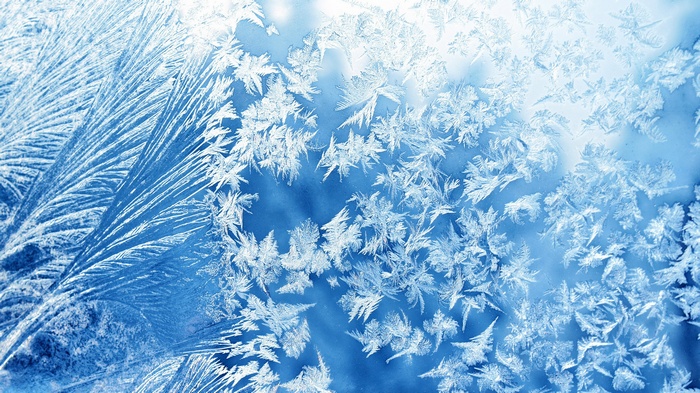 Close-up of frost patterns on a blue surface