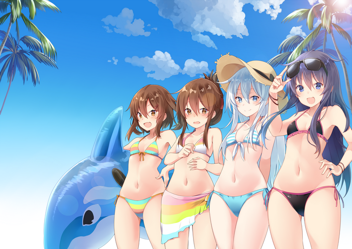 Four girls in swimsuits on a beach with a shark float