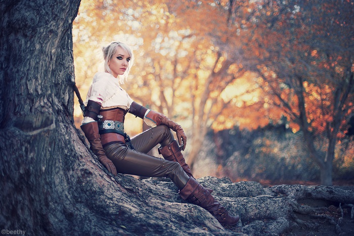 Ciri from The Witcher sitting by a tree