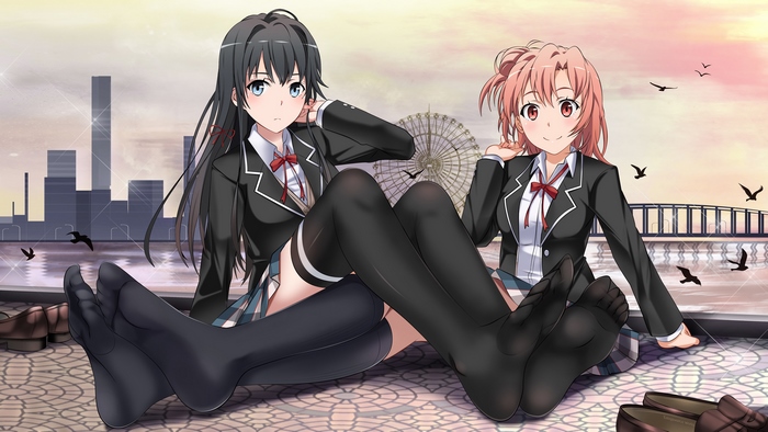 Two girls in school uniforms sitting by a waterfront