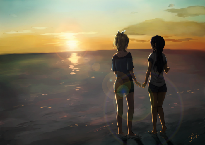 Two girls holding hands at sunset on the beach