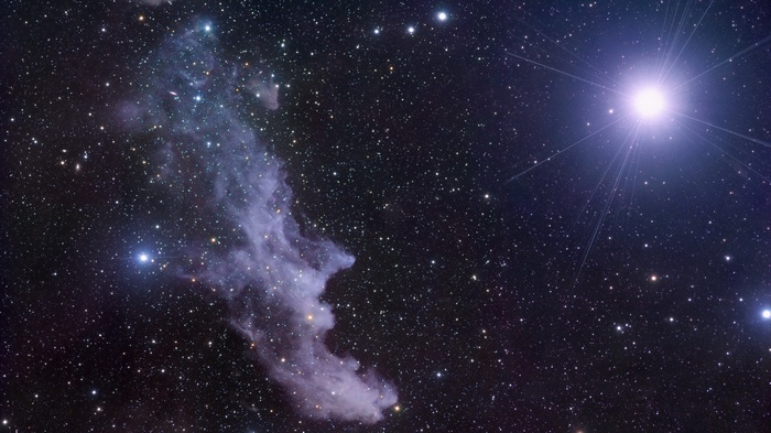 Starry night sky with nebula and bright star