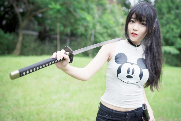 Woman with Mickey Mouse shirt holding a sword
