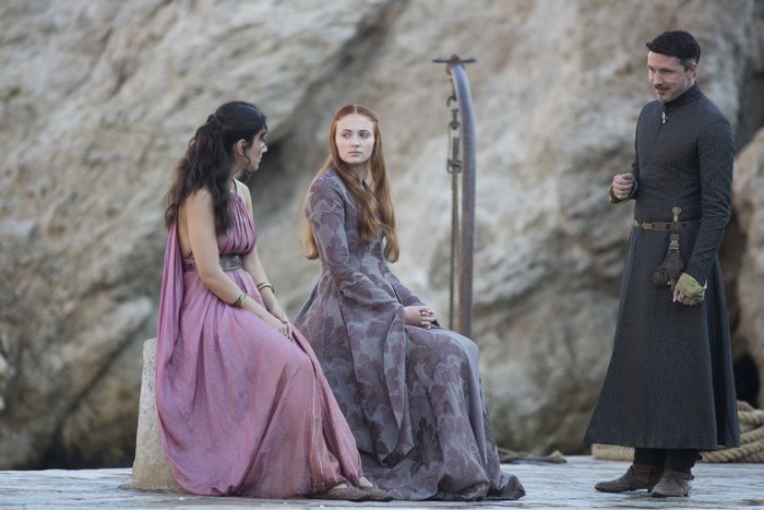 Sansa Stark and two others on a rocky shore