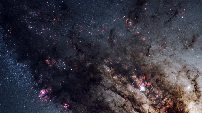 Dusty galaxy with pink nebulae and bright stars