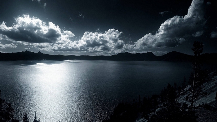 Monochrome lake with mountains and clouds