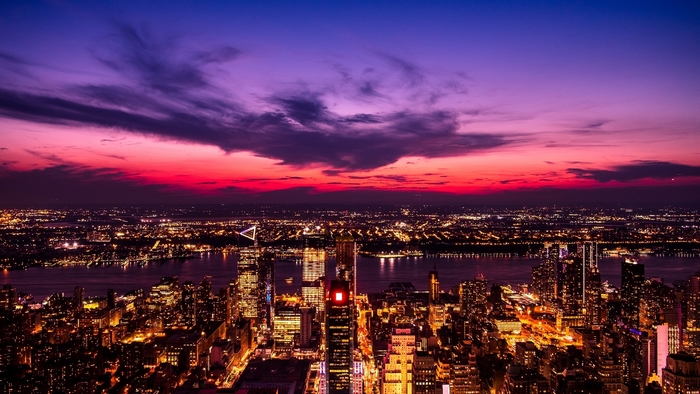 City skyline at dusk with purple and pink sky