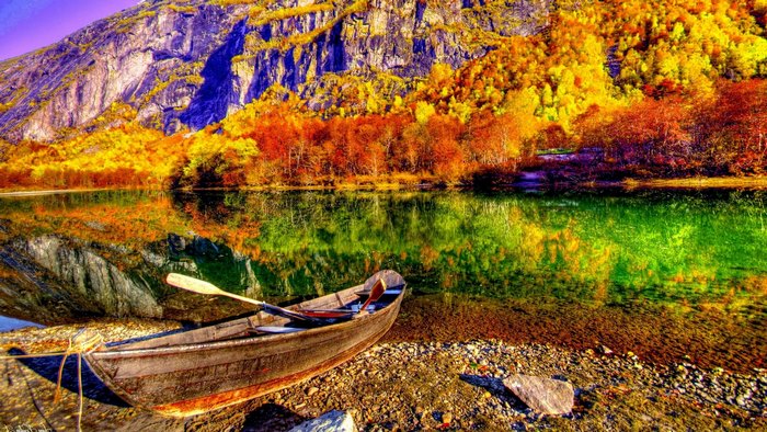 Boat on a lake with autumn mountains