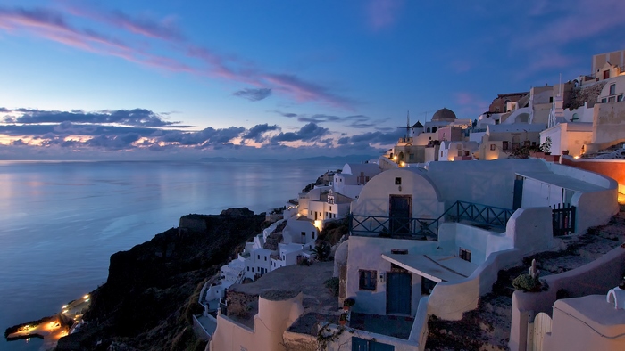 Santorini island at dusk with white houses overlooking the sea
