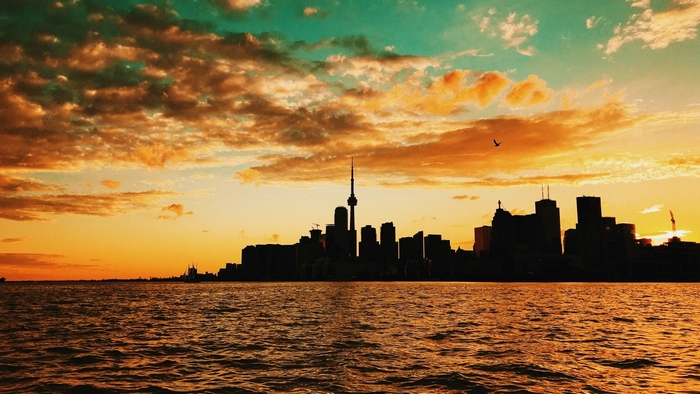 Toronto skyline at sunset over the water