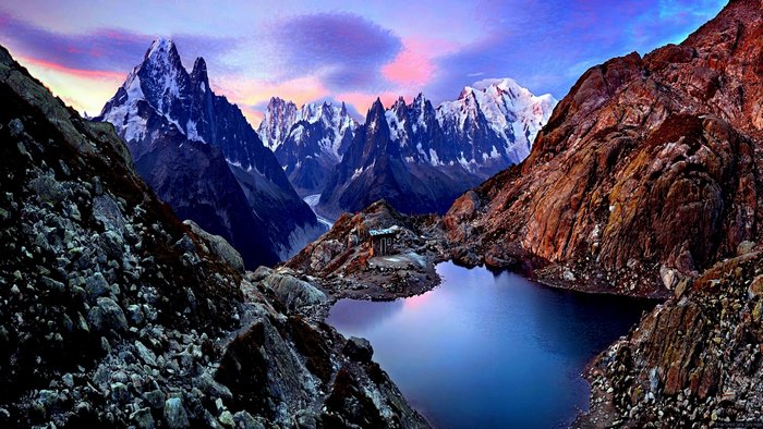 Mont Blanc massif with lake and hut at sunrise