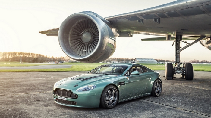 Aston Martin V8 Vantage parked under airplane engine