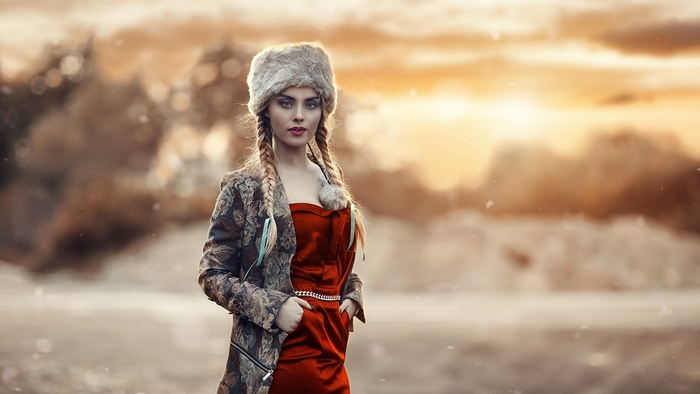 Woman with pigtails and fur hat in winter