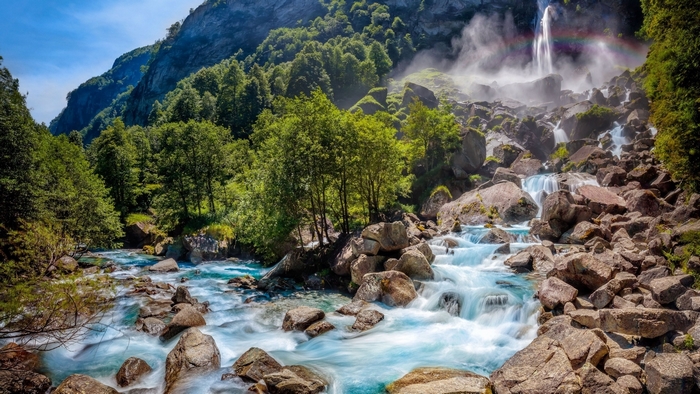Waterfall with Rainbow and River in Switzerland
