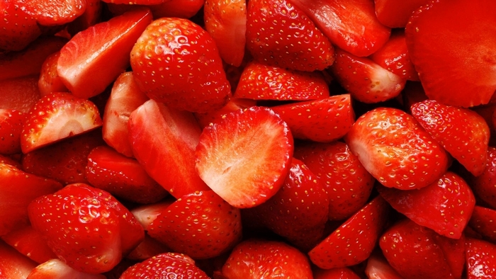 Close-up of sliced and whole strawberries