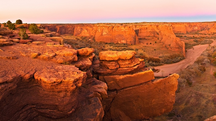Canyon with red rock formations at sunset