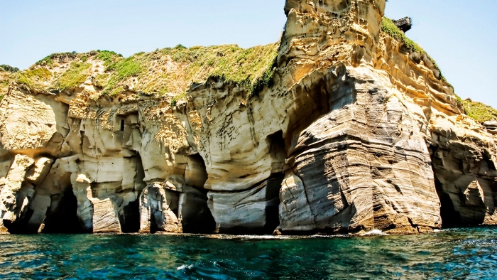Rocky cliffs with caves by the ocean