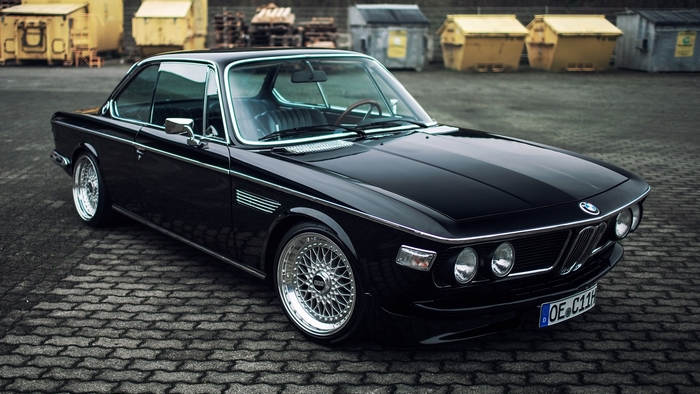 Black BMW E9 CSI parked on cobblestone