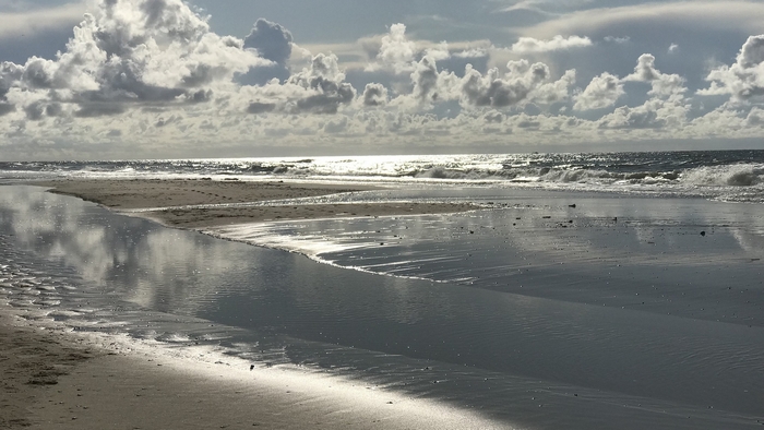 Beach with ocean waves and clouds