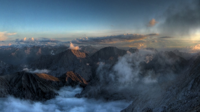 Mountain tops shrouded in mist at sunset