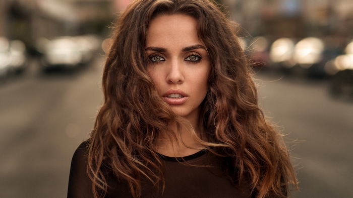 Woman with long brown curly hair