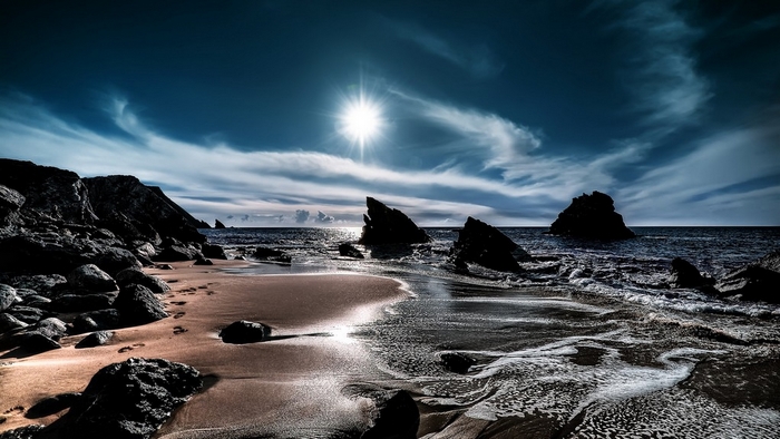 Beach with rocks and sun