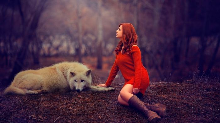 Woman with wolf in a forest