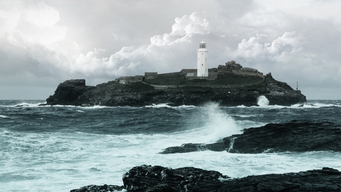 Lighthouse on a rocky island in stormy seas