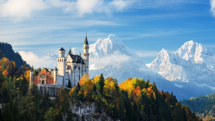 Neuschwanstein Castle in Germany during autumn with mountains