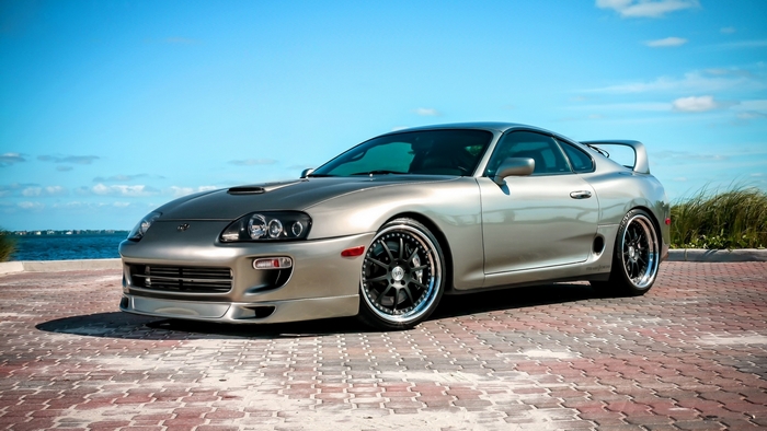 Silver Toyota Supra parked by the water