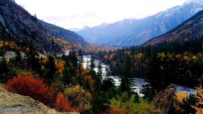 Mountain valley with a river in autumn