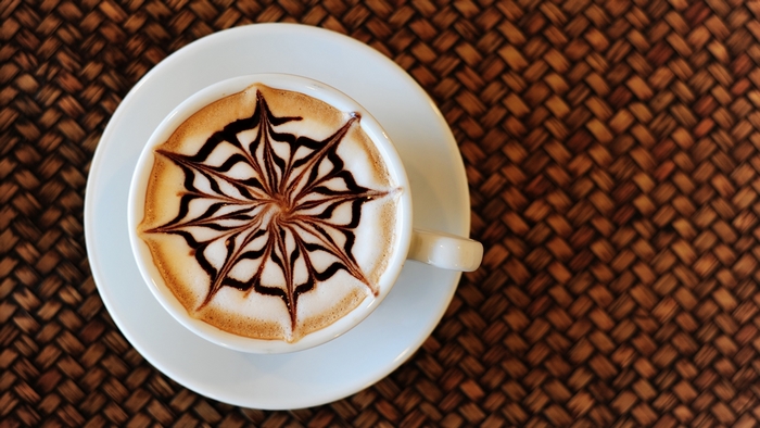 Latte art in a white cup on a saucer