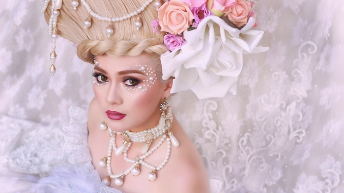 Woman in Marie Antoinette costume with flowers and pearls